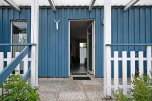 an open door to a blue building at Möve Aba Bungalow 64 in Rerik +16 photos