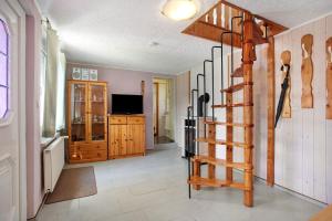 a living room with a spiral staircase in a house at Ferienhaus Pahnke in Bergen auf Rügen