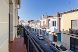 a city street with cars parked on a balcony at La Matea in Llaurí