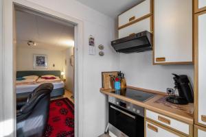 a small kitchen with a bed in a small room at Ferienwohnung Behrens-Reinke in Albstadt