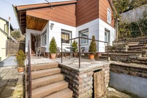a home with a patio and stairs to a house at Ferienwohnung Behrens-Reinke in Albstadt