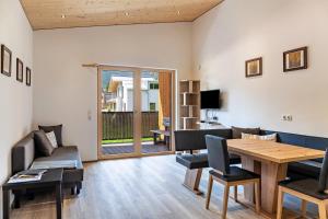 a living room with a couch and a table at Kwelle zur Natur Gamsberg in Obernberg am Brenner