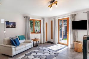a living room with a couch and a tv at Chalet Falkenstein in Garmisch-Partenkirchen