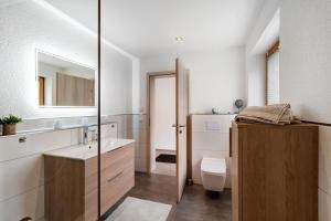 a bathroom with a sink and a toilet at Ferienwohnung Käshammer in Kappelrodeck +17 photos