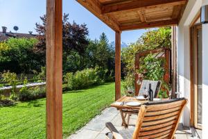 a patio with a table and chairs in a yard at Chalet Falkenstein in Garmisch-Partenkirchen +51 photos