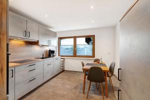 a kitchen with a table and a dining room at Ferienwohnung Käshammer in Kappelrodeck