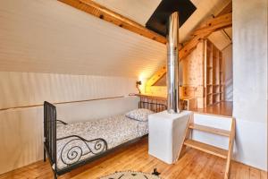 a bedroom with a bed in a room with wooden ceilings at L'atelier M in Quaix