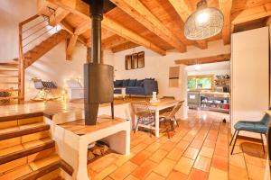 a kitchen and living room with a stove in a house at L'atelier M in Quaix +14 photos