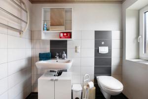 a small bathroom with a sink and a toilet at Ferienwohnung Horstmann in Meldorf +20 photos