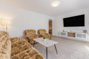 a living room with couches and a flat screen tv at Edificio El Baifo Loco - Constantin in Gran Tarajal