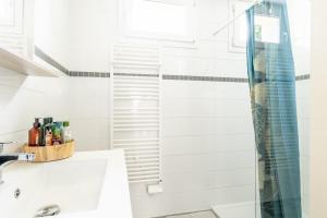 a bathroom with a shower and a sink at Maison Ker Morin La Gacilly in La Gacilly +14 photos