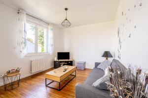a living room with a couch and a coffee table at Maison Ker Morin La Gacilly in La Gacilly