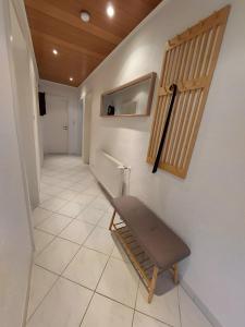 a hallway with a bench sitting on a tiled floor at Ferienhaus Dorfidylle in Oberzent