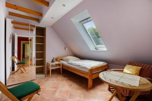 a attic bedroom with a bed and a window at Ferienhaus Siegfried in Niebüll