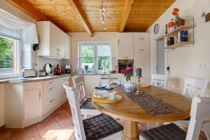 a kitchen and dining room with a wooden table and chairs at Ferienhaus Siegfried in Niebüll