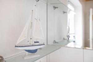 a toy boat sitting on a counter in a bathroom at Ferienhaus Siegfried in Niebüll +21 photos
