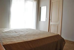 a bed in a room with a large window at Villa Florida 2 with private pool in San Teodoro