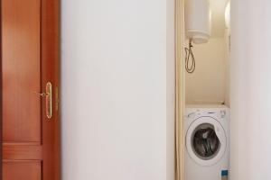 a door leading to a laundry room with a washing machine at Little Dunes in Corralejo