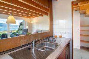 a kitchen with a sink and a large mirror at Merk Ferienwohnungen Gbr in Bodman-Ludwigshafen +242 photos