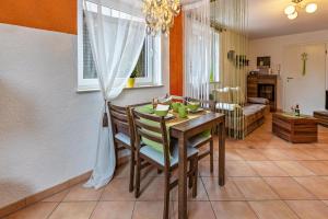 a kitchen and dining room with a table and chairs at Ferienwohnung Im Holzhaus in Donaueschingen