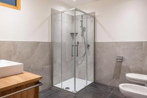 a shower with a glass door in a bathroom at Mittnackerhof Apartment Kamille in Sarntal