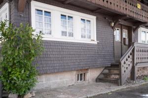 a house with a white window and a staircase at Schwarzwaldcasa in Todtmoos