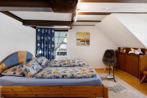 a bedroom with a bed with a blue comforter at Schwarzwaldcasa in Todtmoos
