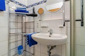 a bathroom with a sink and a mirror and towels at Ferienwohnung Keller in Hagnau +45 photos