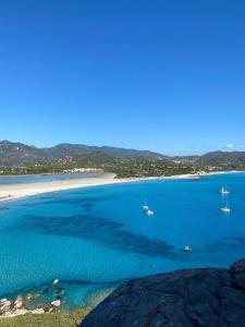 a view of a beach with boats in the water at Casa Vacanza Casi 1 in Villasimius