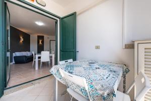 a dining room with a table and chairs in a room at Casa Vacanza Casi 1 in Villasimius +18 photos