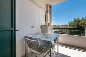 a small balcony with a table and chairs on a patio at Casa Vacanza Casi 1 in Villasimius