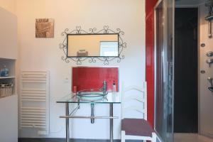 a bathroom with a glass sink and a mirror at L'abreuvoir du Leffo in Allineuc +20 photos