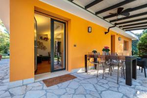 an outdoor patio with a wooden table and chairs at Le dimore di Elia in Lecce