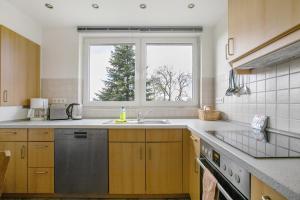 a kitchen with a sink and a window at Ferienwohnung Nico in Langballig