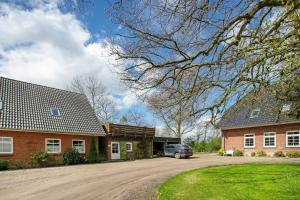 a car parked in front of a brick house at Ferienwohnung Nico in Langballig