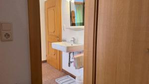a bathroom with a sink and a mirror at Birkenhof in Leutasch +29 photos