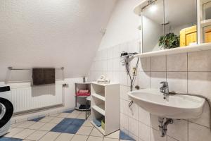 a bathroom with a sink and a mirror at Hus Tingeltut Gerd Clausen in Pellworm +52 photos