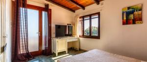 a living room with a television and a window at Villa Pia in Uta