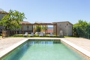 a swimming pool in the backyard of a house at Can Malràs in Massanas