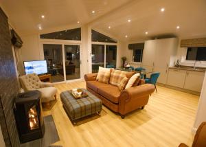 a living room with a couch and a stove at Drumcarrow Luxury Lodges in St. Andrews +71 photos