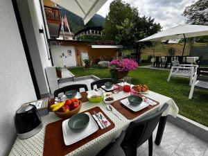 a table with food on it on a patio at Loft Casa Facco in Bocenago