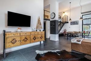 a living room with a tv on a wall at Loft Casa Facco in Bocenago