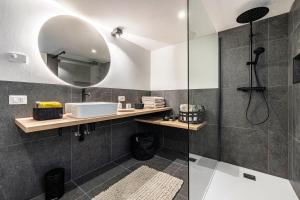 a bathroom with a sink and a shower at Loft Casa Facco in Bocenago +27 photos