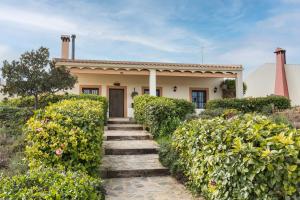 a house with a staircase leading up to it at Finca Liarte in Murcia