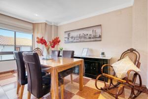 a dining room with a wooden table and chairs at La bodegueta in Orba
