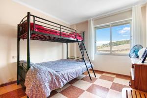 a bedroom with two bunk beds and a window at La bodegueta in Orba