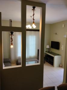 a room with a living room with a couch and a television at Anemi Leros Apartments 2 in Panteli