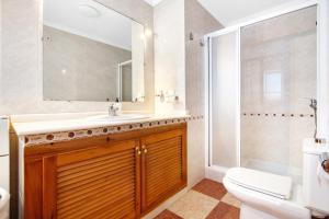 a bathroom with a sink and a toilet and a mirror at La bodegueta in Orba