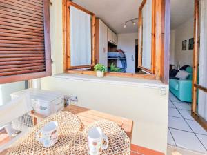 a room with a table and two windows at Mono Le Lecce 53 Iris in Capoliveri