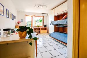 a room with a table and a room with a bed at Mono Le Lecce 53 Iris in Capoliveri